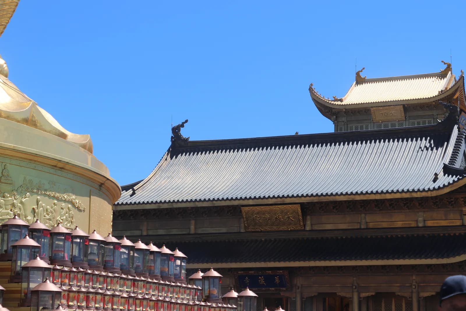 Huazang Temple and the golden halls of the Golden Summit of Mount Emei under a blue sky
