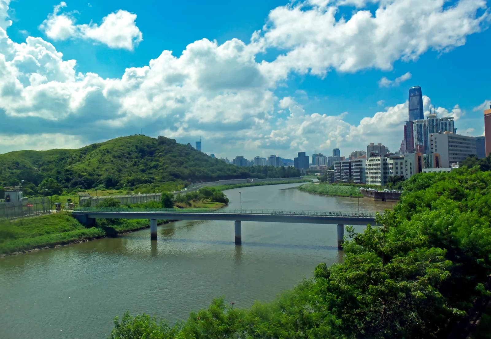 View across the Shenzhen River from Lo Wu station in Hong Kong toward the Shenzhen skyline and Luohu border crossing