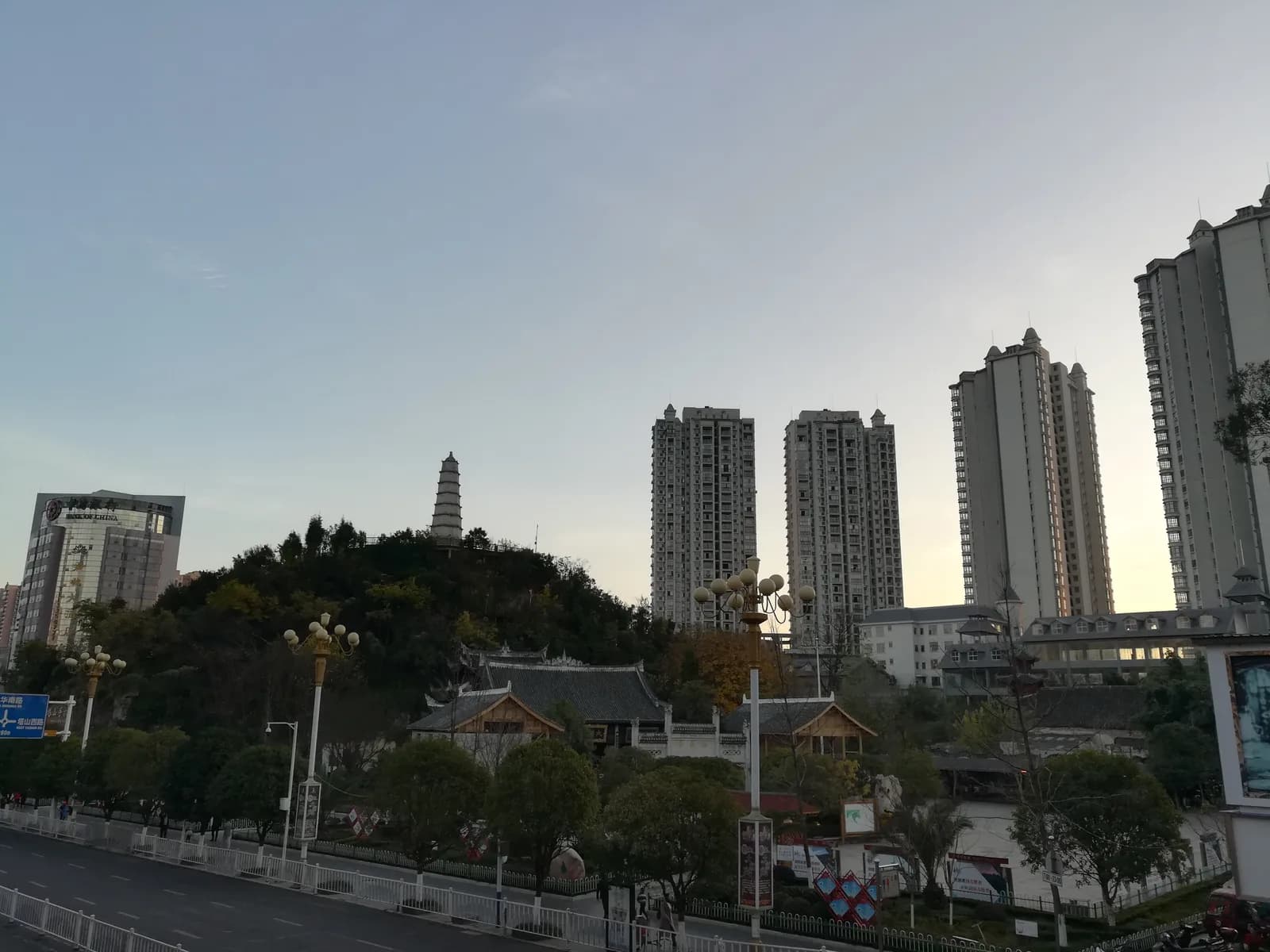 A traditional multi-tiered tower rising above the rooftops of downtown Anshun, Guizhou