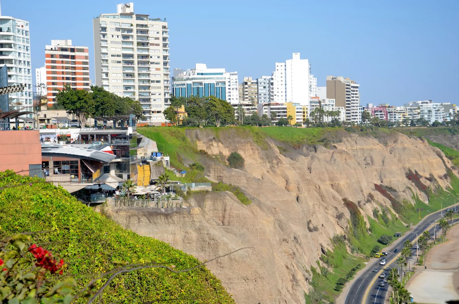 The Larcomar mall built into the Miraflores cliff face with the high-rise skyline above the Costa Verde in Lima