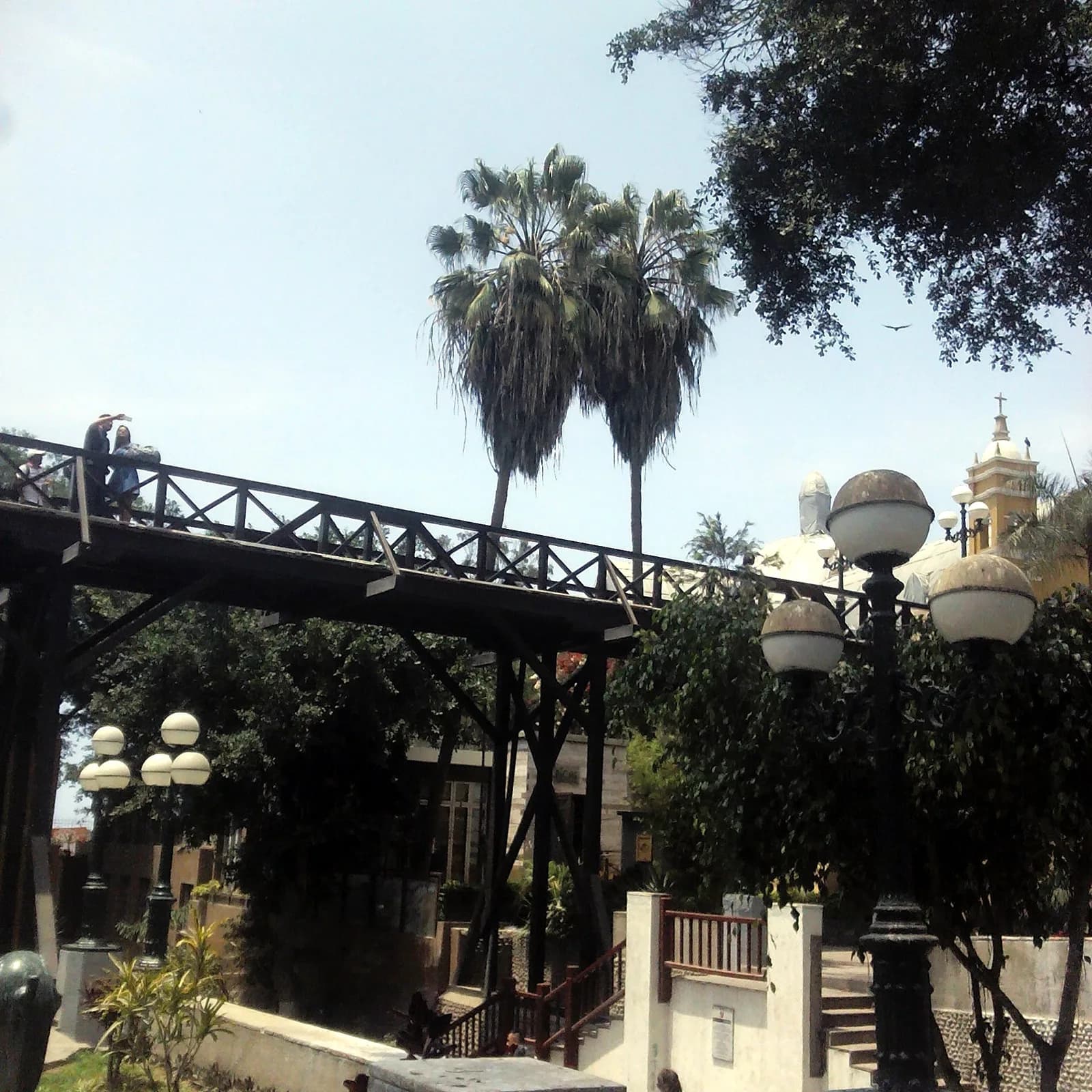 The wooden Puente de los Suspiros, the Bridge of Sighs, surrounded by greenery in Barranco, Lima