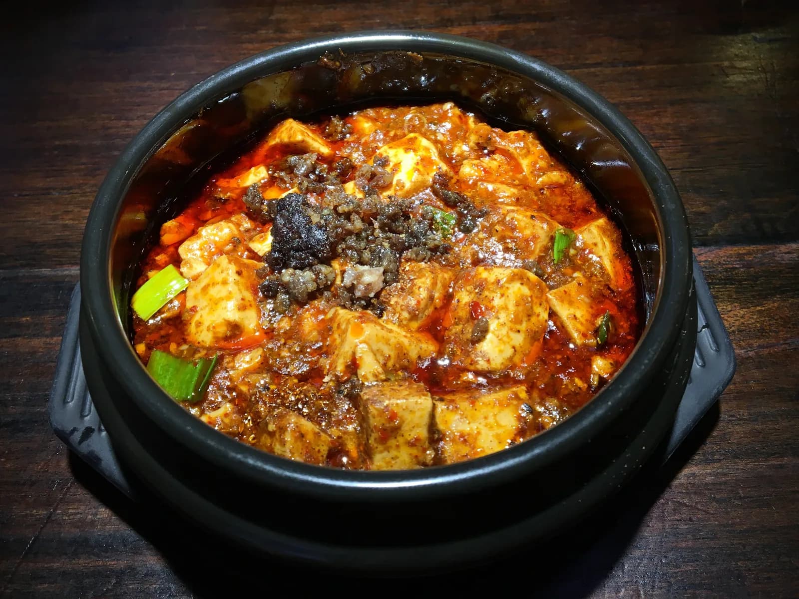A bowl of mapo tofu topped with minced beef, chili oil and Sichuan pepper, served at Chen Mapo Tofu in Chengdu