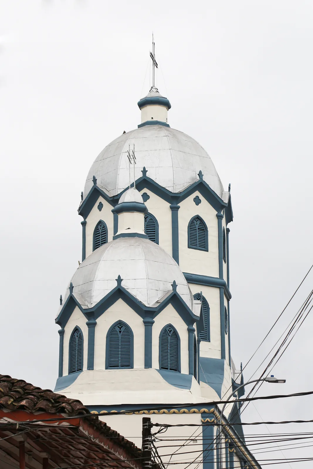 The grey stone facade of the Iglesia de la Inmaculada Concepcion church on Filandia's main plaza