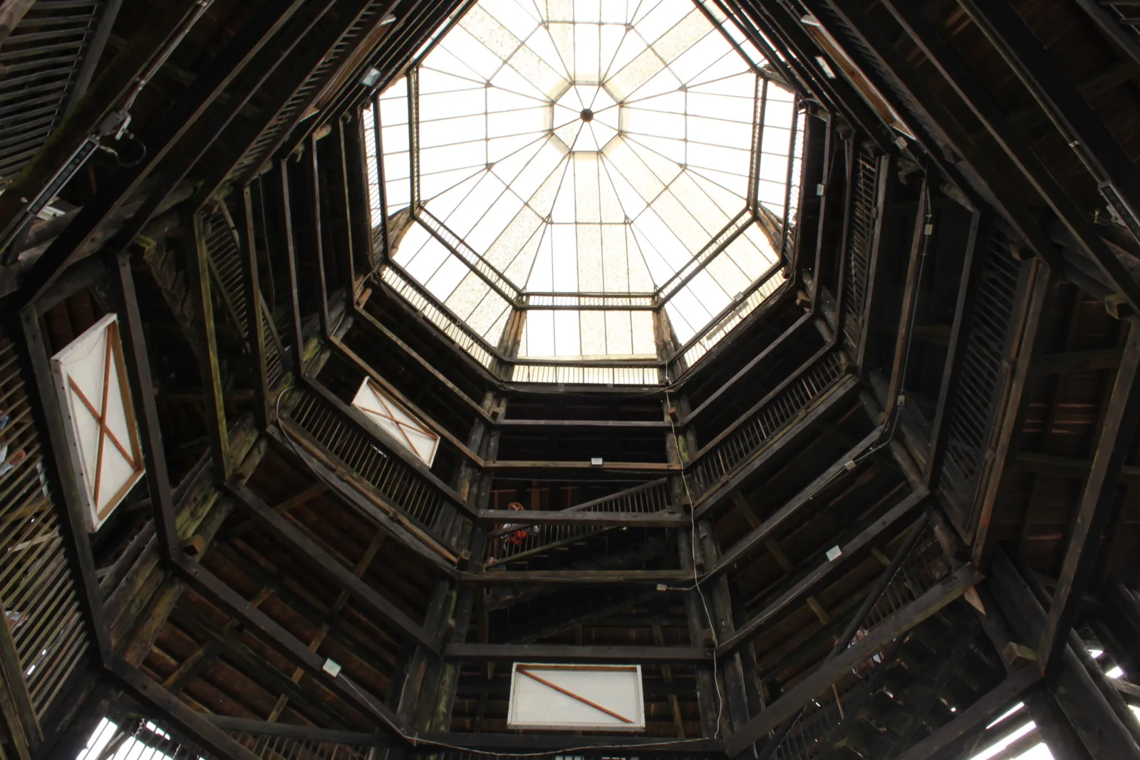 Looking up through the octagonal wooden lattice interior of the Mirador Colina Iluminada tower in Filandia