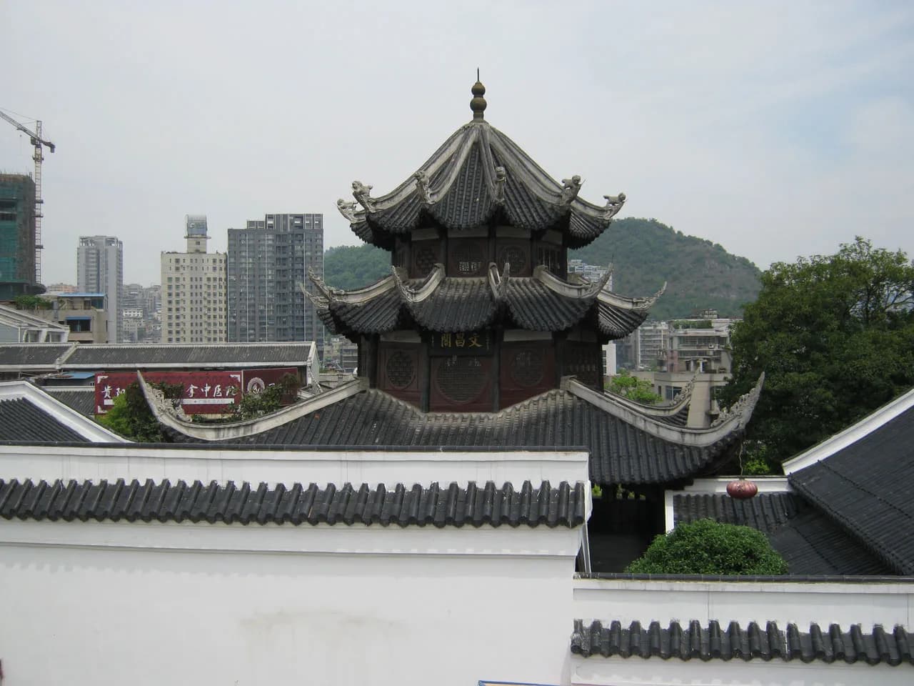 The tiered wooden Wenchang Pavilion rising above the old city wall in Guiyang