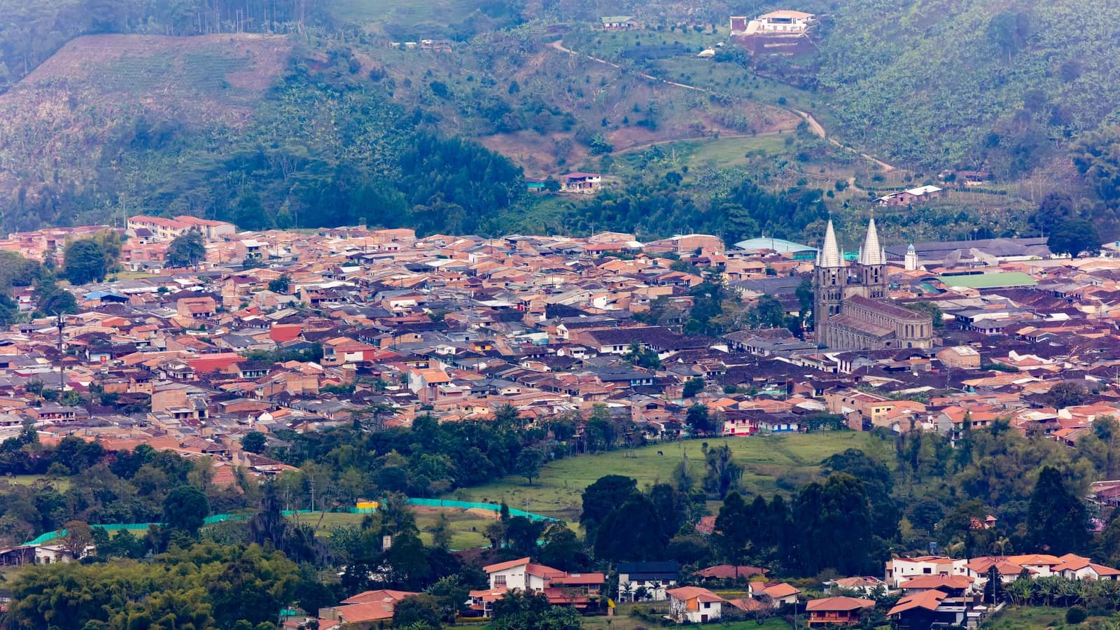 The town of Jardín, Antioquia seen from the hills above, with the basilica towers rising over the rooftops