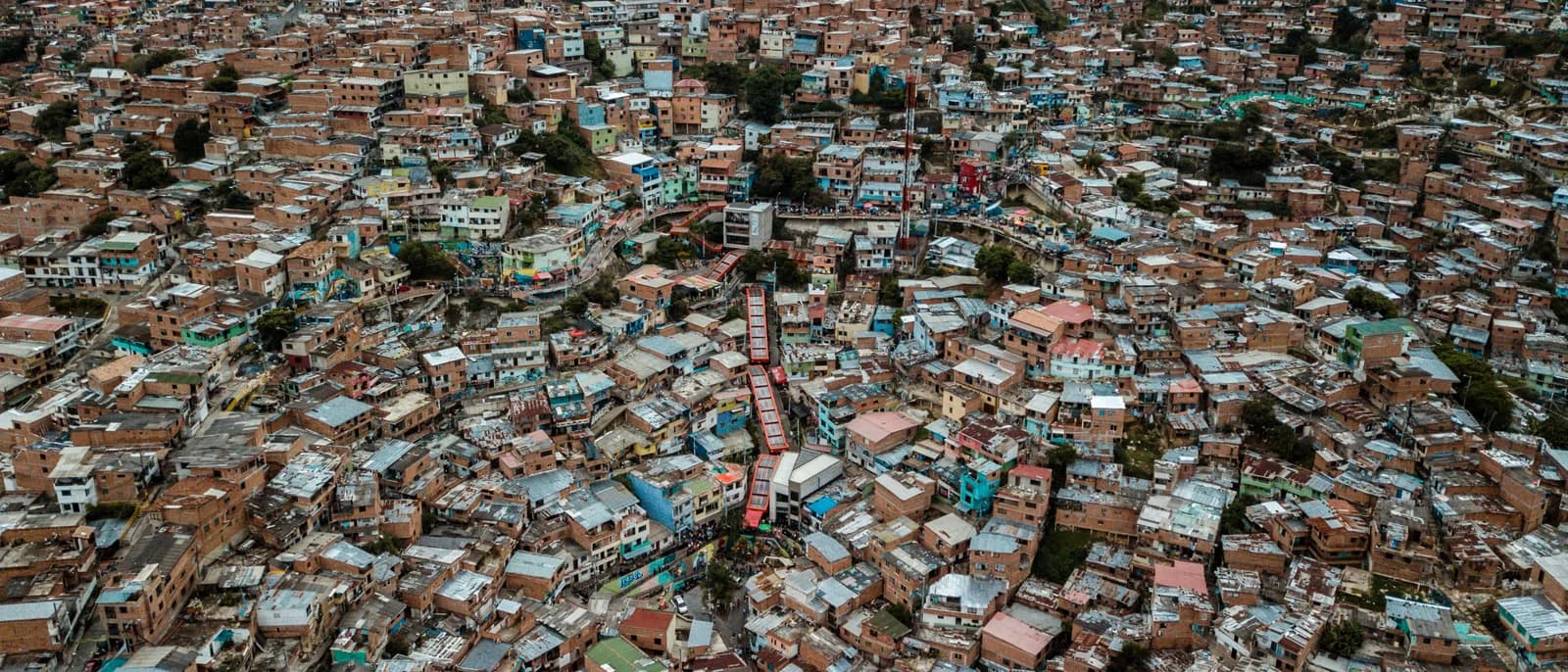 The covered outdoor escalators of Comuna 13 running up the mural-covered hillside in Medellín, Colombia