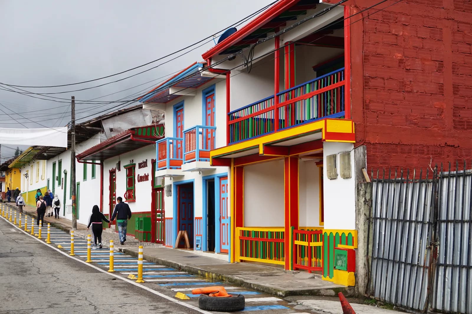 Brightly painted shopfronts and balconies along Calle Real, the main street of Salento, Colombia