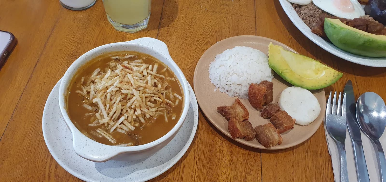 A bowl of paisa red beans topped with chicharrón, served in Medellín, Colombia