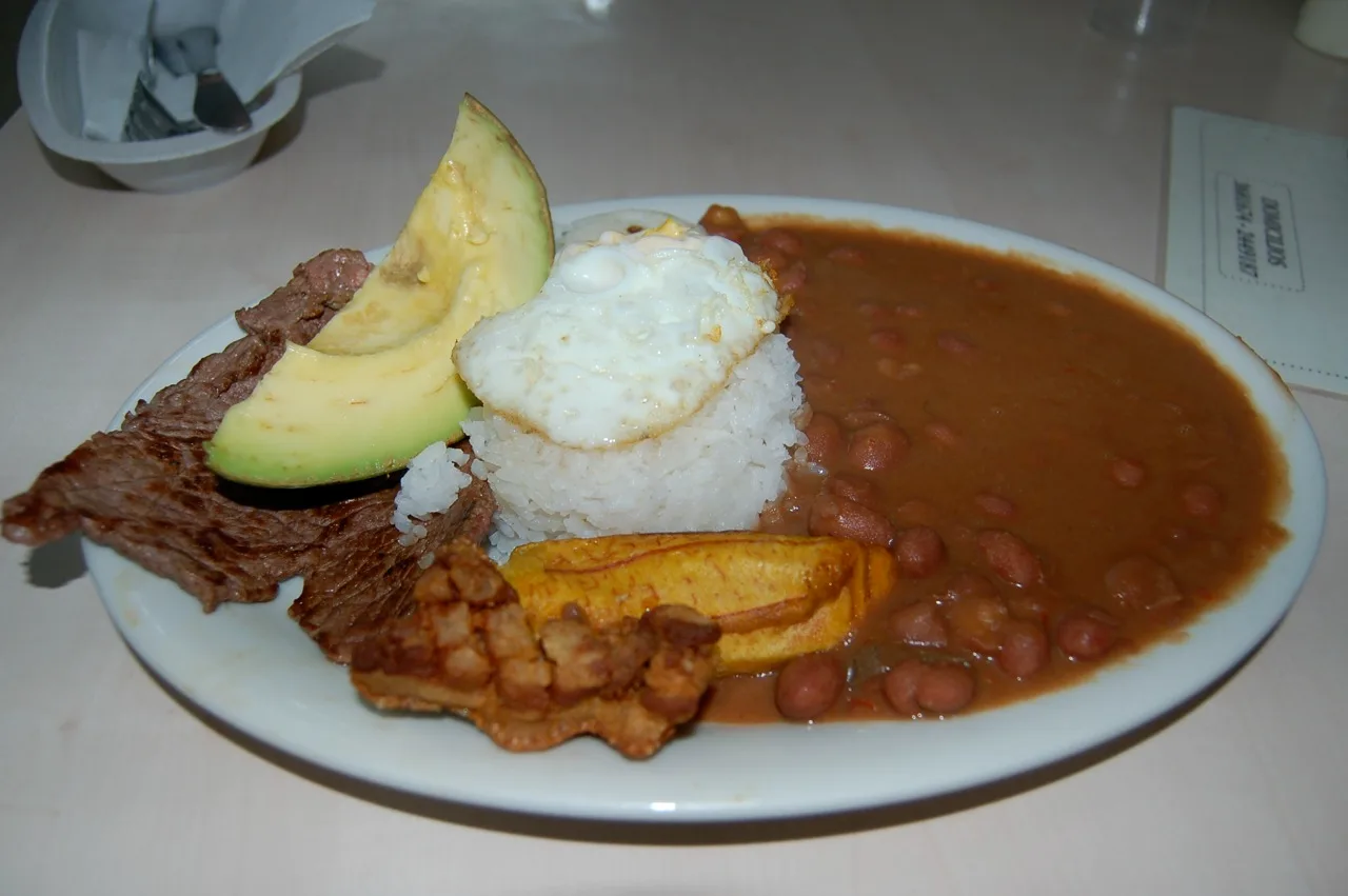A full bandeja paisa platter with beans, chicharrón, chorizo, fried egg, rice, avocado, plantain and an arepa, Antioquia, Colombia