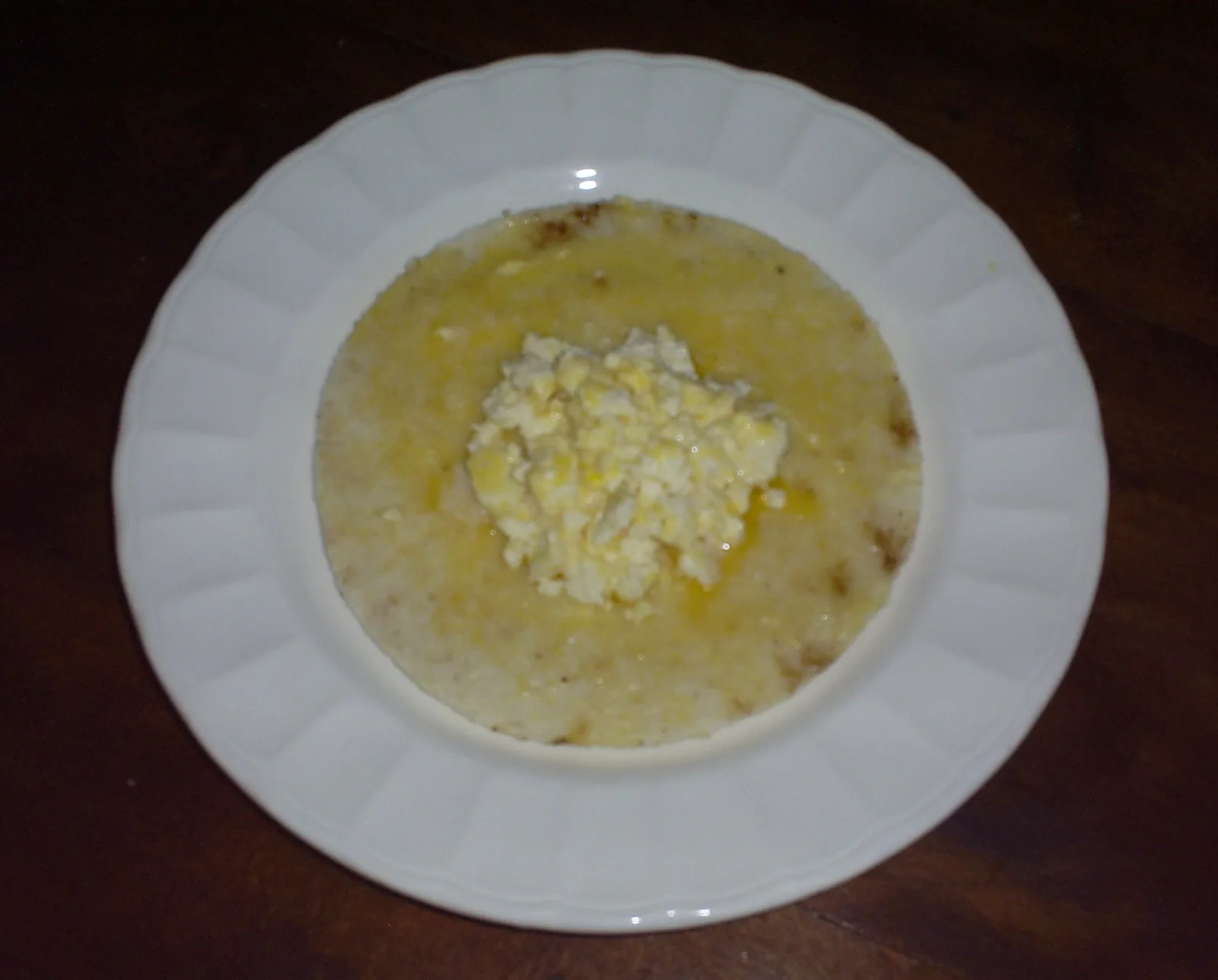 A paisa arepa served with a slab of fresh white quesito cheese, Antioquia, Colombia