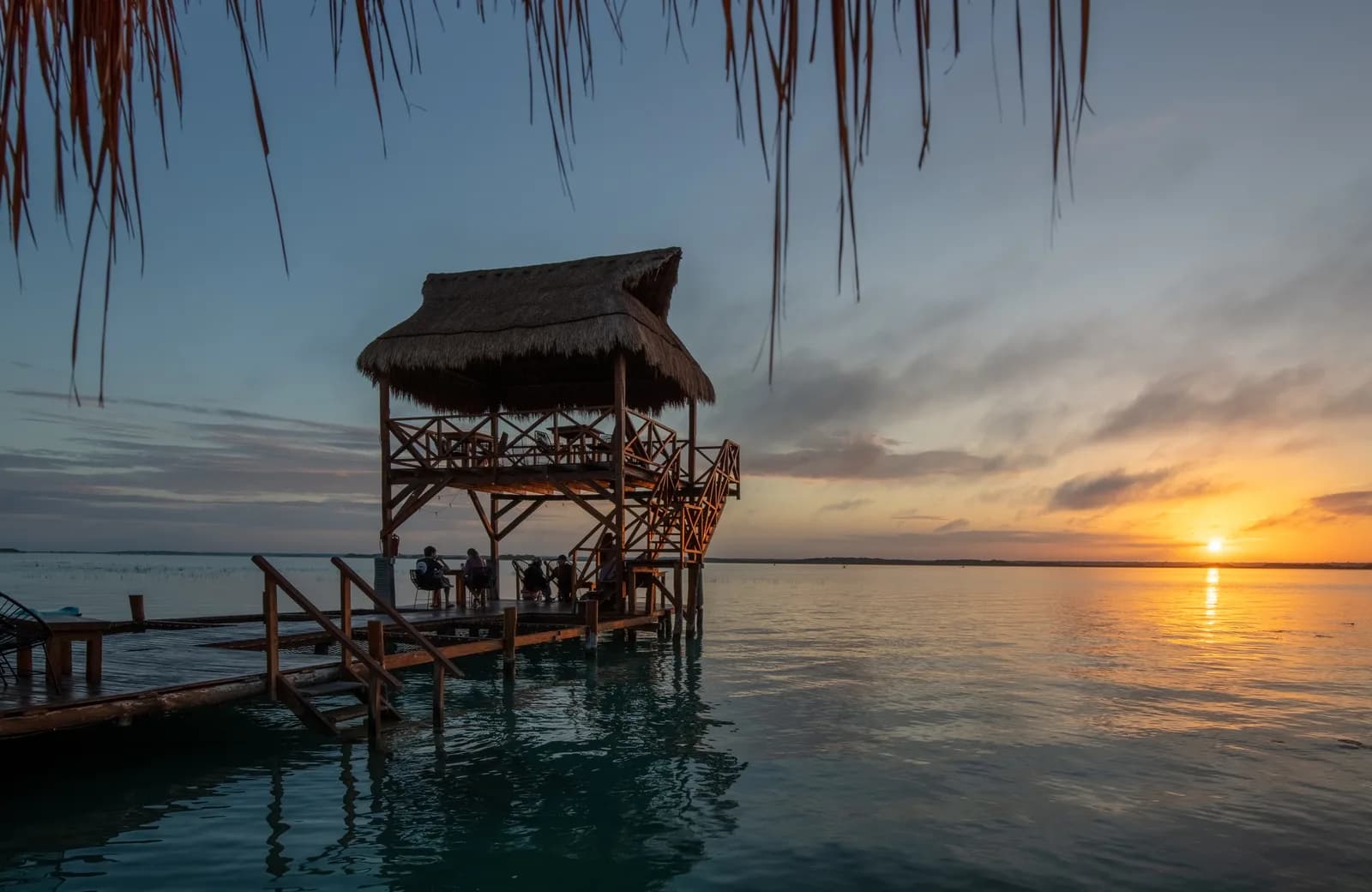 The turquoise and deep-blue bands of the Lagoon of Seven Colors at Bacalar, Mexico, at sunrise