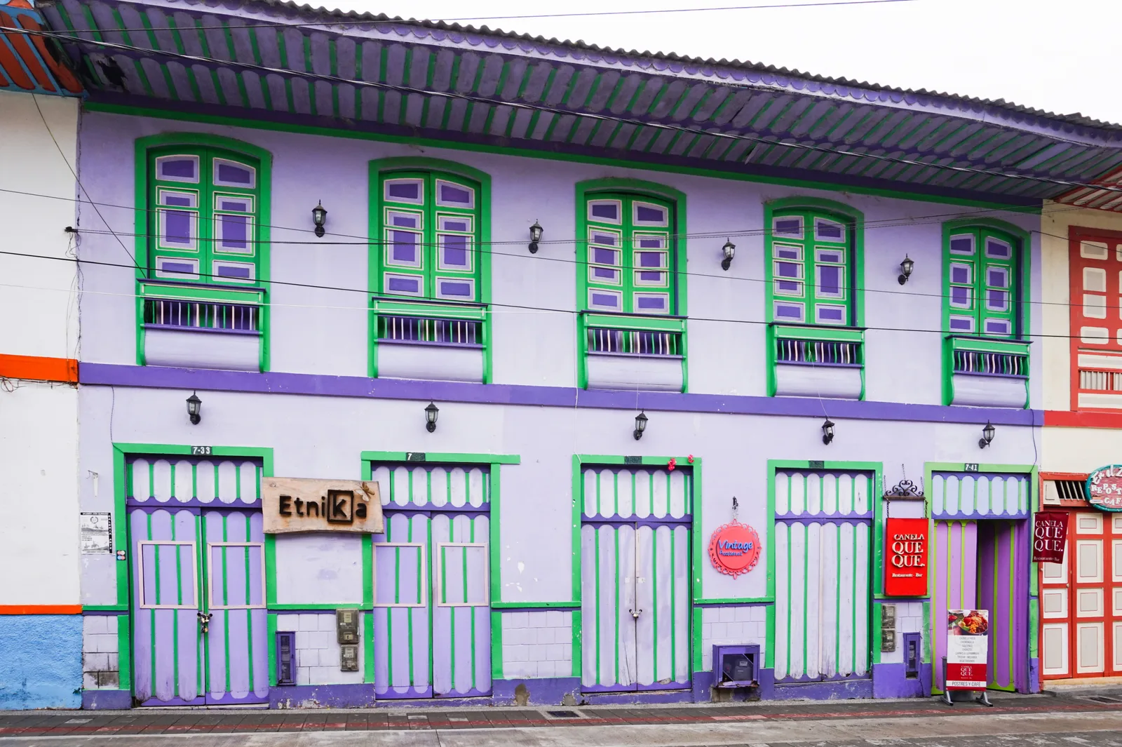 A traditional two-story building with ornate painted balconies in the center of Filandia, Colombia