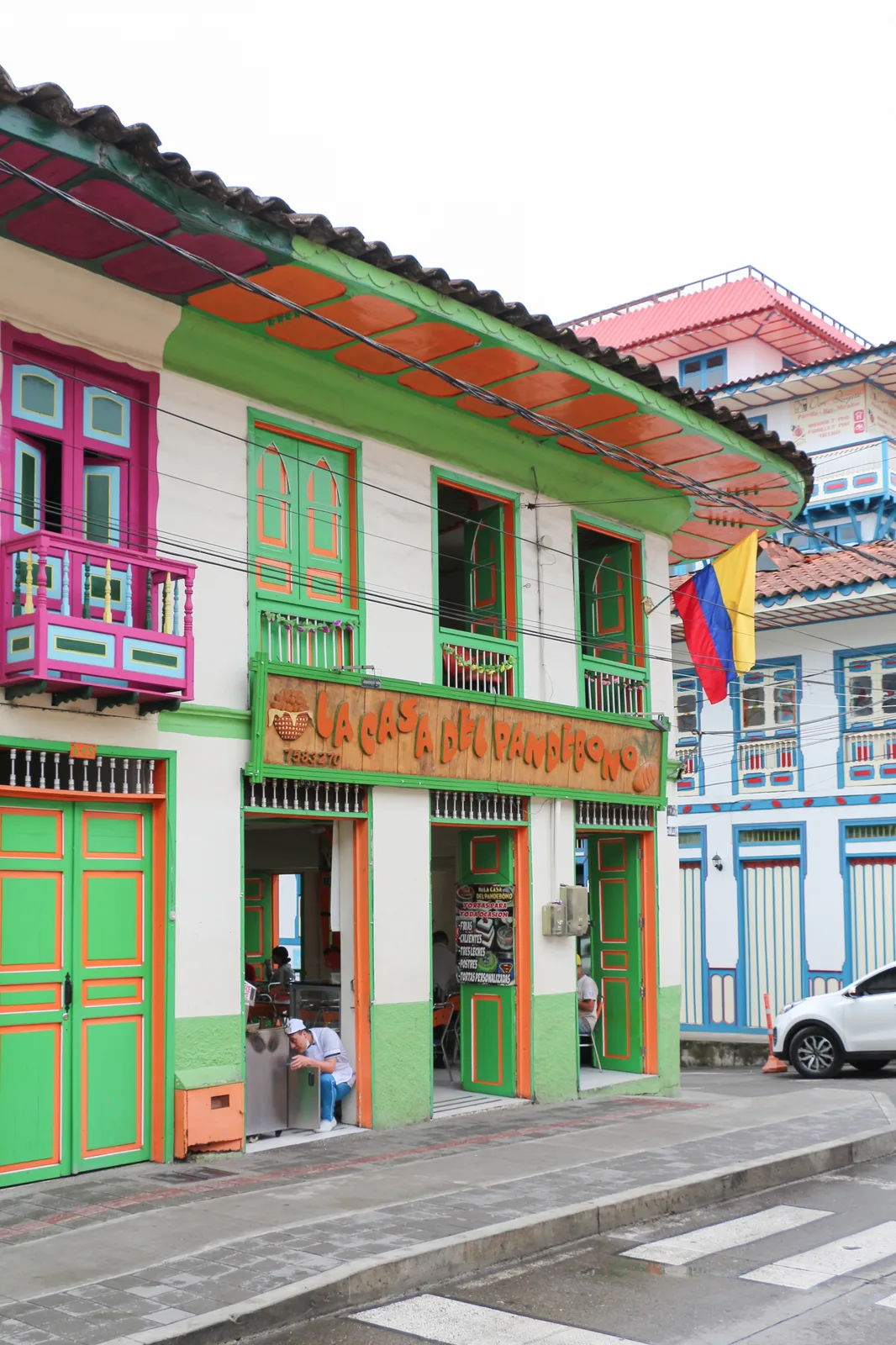 The painted facade of La Casa del Pandebono bakery on a corner in Filandia, Colombia
