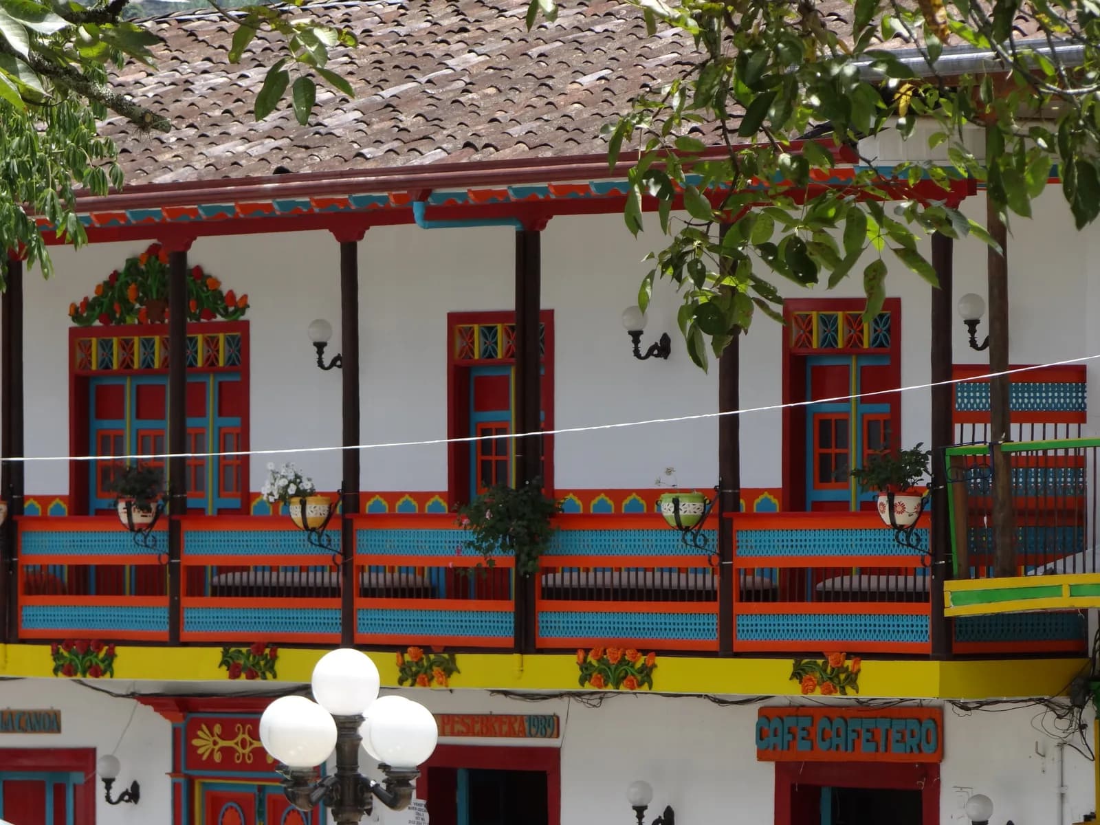 A traditional Antioquian house with painted balconies facing the main plaza of Jardín, Colombia
