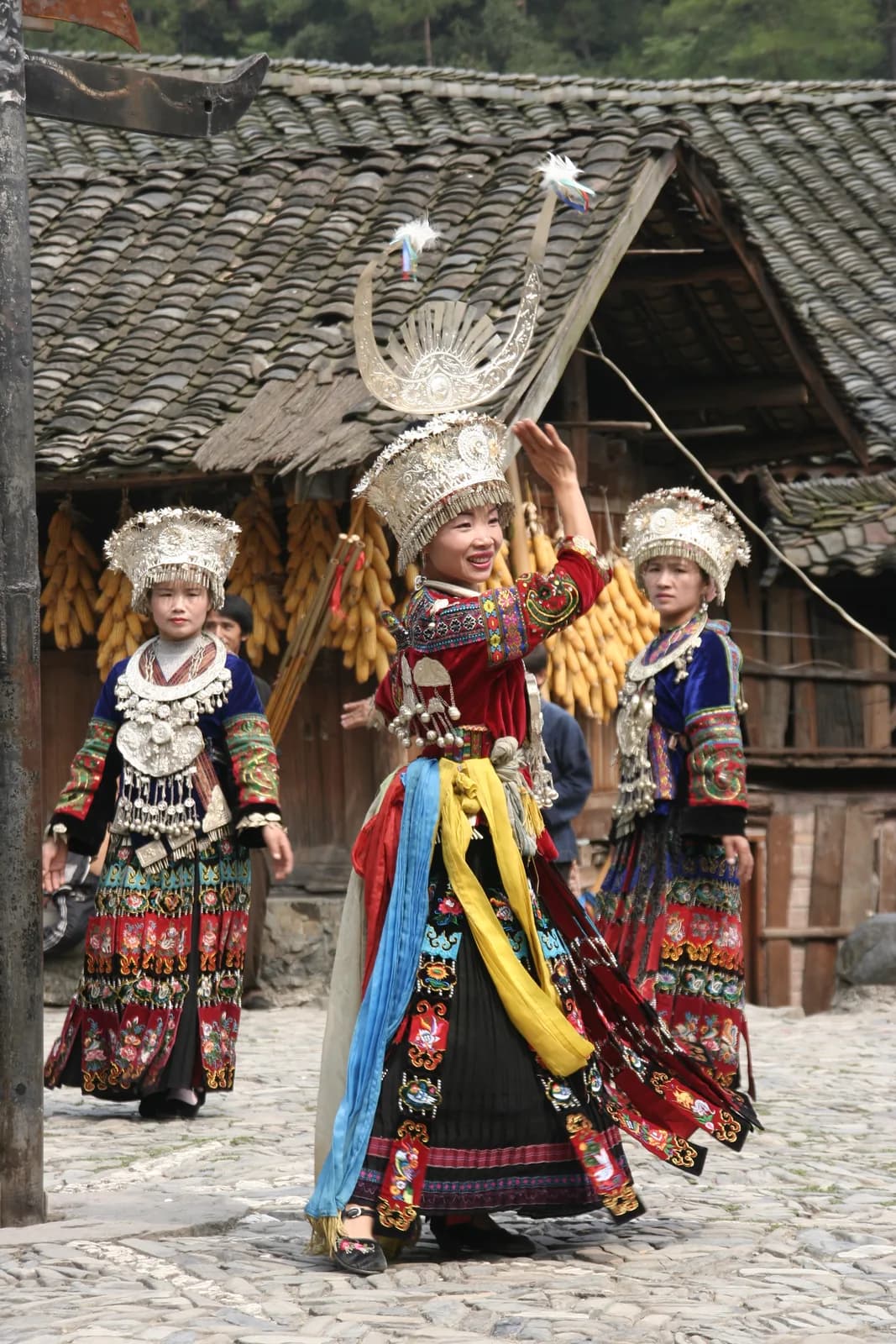 Miao villagers in traditional dress performing a welcome ceremony in Langde Upper Village near Kaili