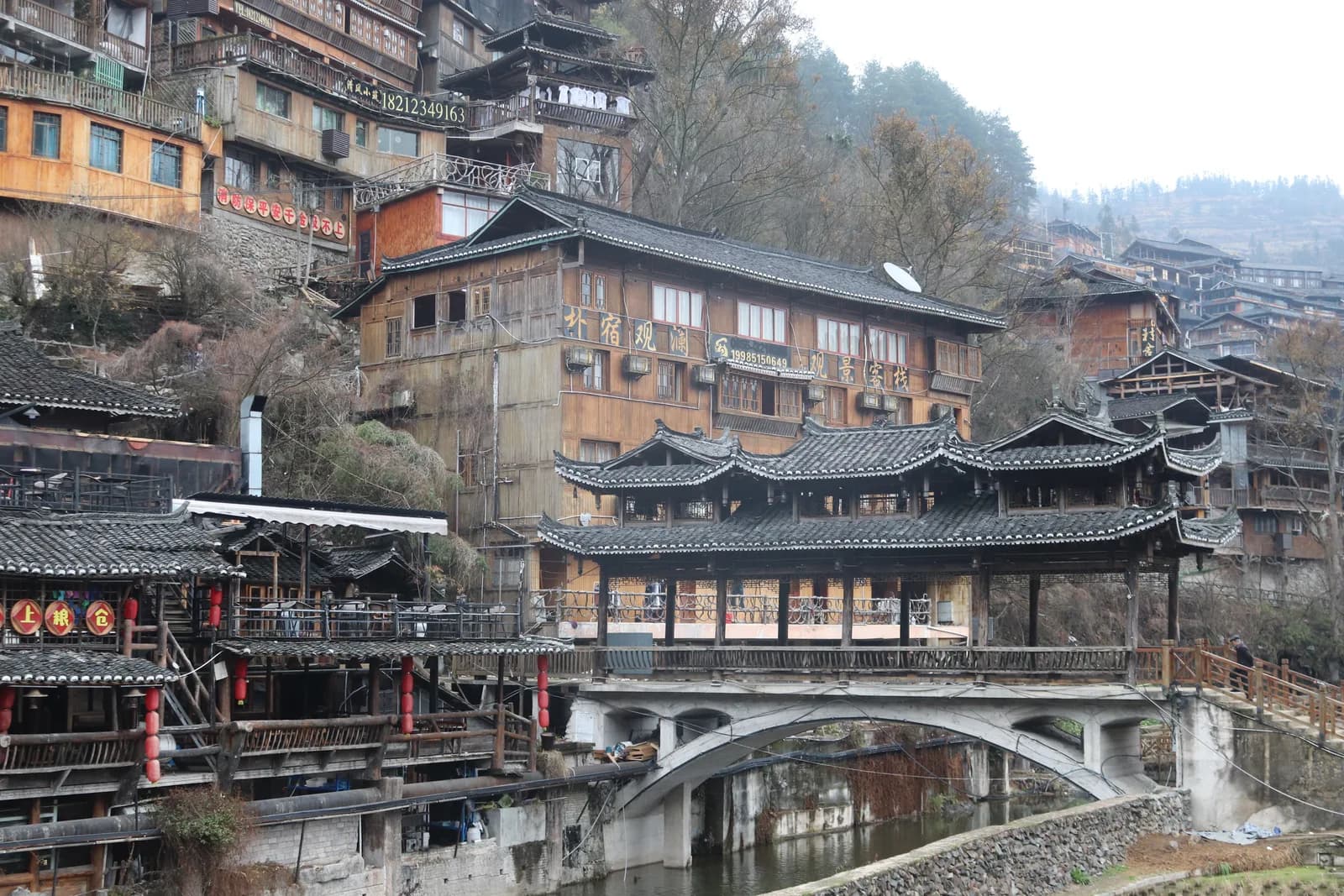 Covered wooden wind-and-rain bridge number one spanning the Baishui River in Xijiang Miao Village
